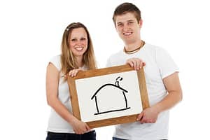 couple holding picture of a house